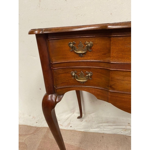 10 - A QUEEN ANNE STYLE WALNUT DESK, serpentine front with two drawers having brass handles, supported by... 