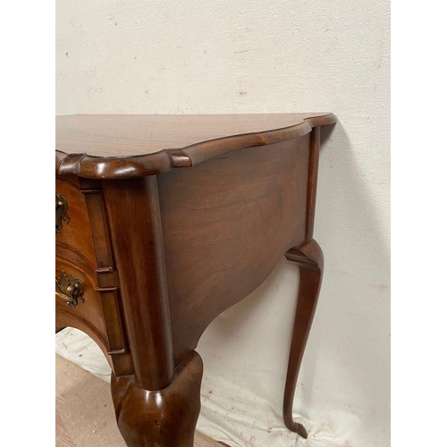 10 - A QUEEN ANNE STYLE WALNUT DESK, serpentine front with two drawers having brass handles, supported by... 