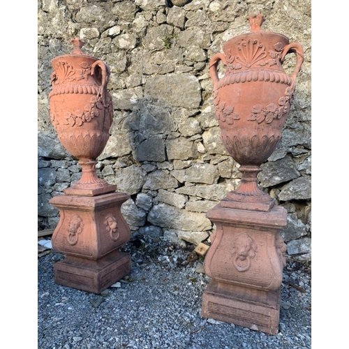 101 - A PAIR OF TERRACOTTA GARDEN URNS, each with classical design, two handles, shell motif to front, fin... 