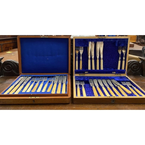 112 - A PAIR OF CASED SILVER PLATED CUTLERY SETS, case with gilt cartouche to top, opening to engraved fis... 