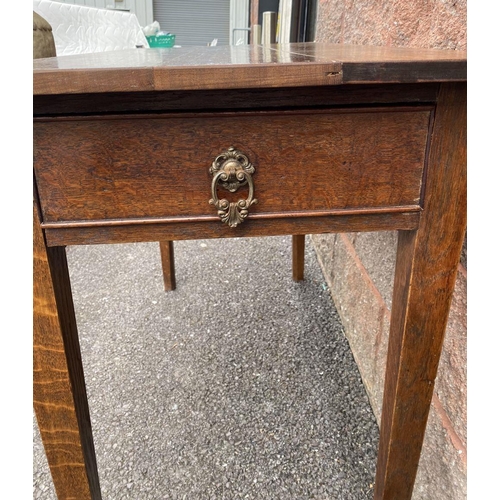 117 - AN ANTIQUE MAHOGANY SIDE TABLE, drawers to either side with ornate brass handles, standing on tapere... 