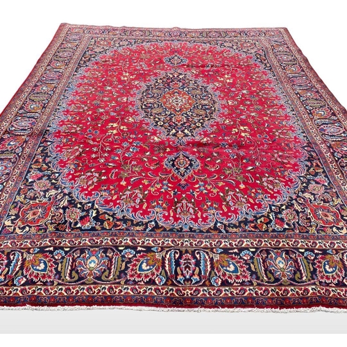 12 - A LARGE PERSIAN MASHAD RUG, material: hand spun wool with natural organic dyes; design: this rug fea... 