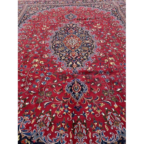 12 - A LARGE PERSIAN MASHAD RUG, material: hand spun wool with natural organic dyes; design: this rug fea... 