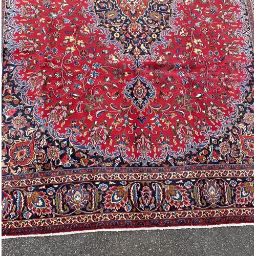 12 - A LARGE PERSIAN MASHAD RUG, material: hand spun wool with natural organic dyes; design: this rug fea... 