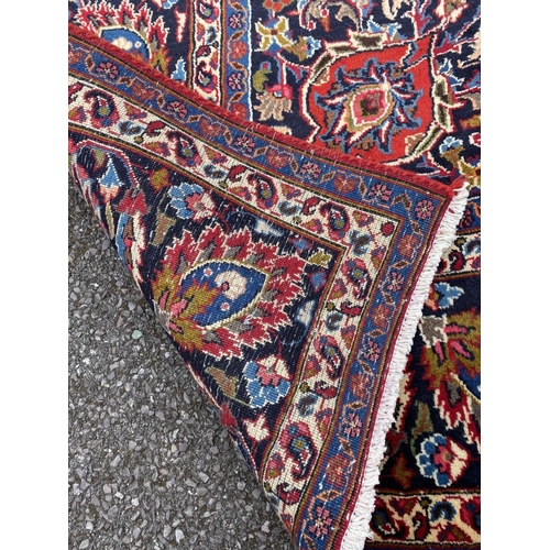 12 - A LARGE PERSIAN MASHAD RUG, material: hand spun wool with natural organic dyes; design: this rug fea... 