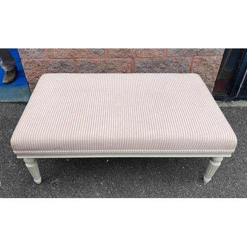 128 - AN UPHOLSTERED OTTOMAN BENCH, upholstered with pale striped fabric, standing on turned leg, painted ... 