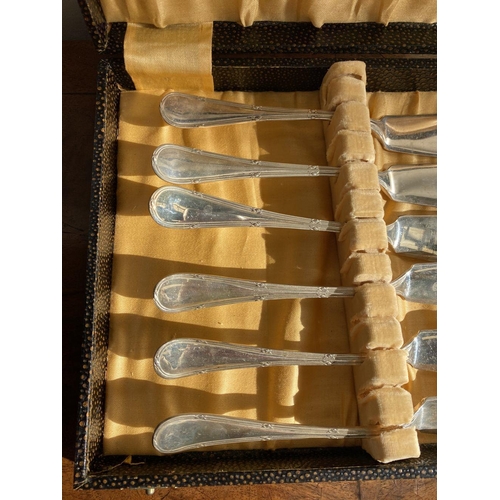 135 - A CASED SET OF FOUR FISH KNIVES, silver plated, with engraved handles.