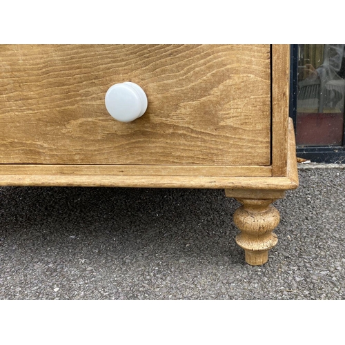 149 - A VICTORIAN PINE CHEST OF DRAWERS, two over three drawers, with porcelain handles, standing on short... 