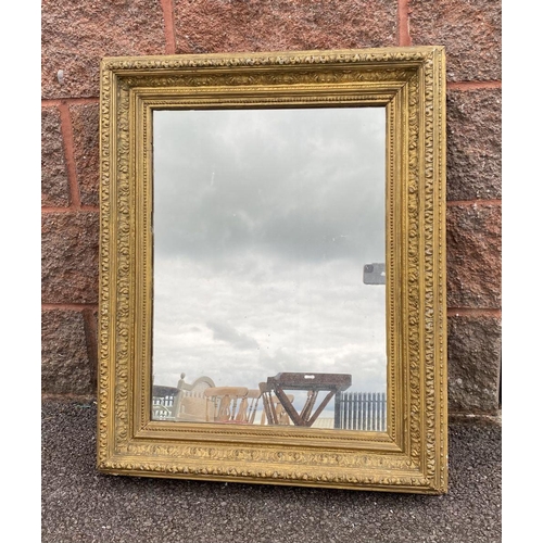 15 - AN ANTIQUE GILT WALL MIRROR, rectangular form, ornately carved with foliate design, dimensions: 66cm... 