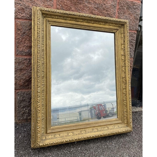 15 - AN ANTIQUE GILT WALL MIRROR, rectangular form, ornately carved with foliate design, dimensions: 66cm... 