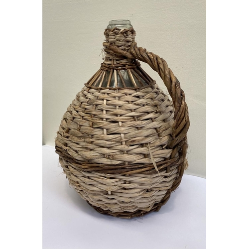 160 - A VINTAGE FRENCH WICKER HANDLED DEMIJOHN WINE BOTTLE, glass bottle in woven wicker cover, used to pr... 