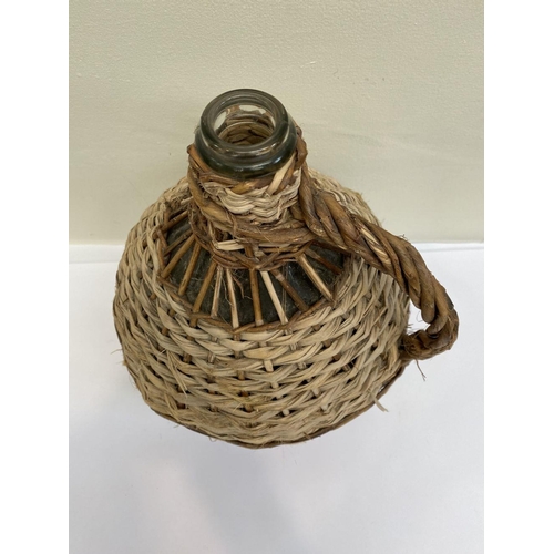 160 - A VINTAGE FRENCH WICKER HANDLED DEMIJOHN WINE BOTTLE, glass bottle in woven wicker cover, used to pr... 