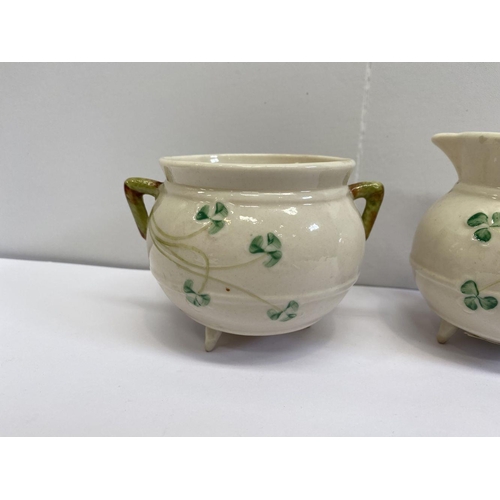 191 - A VINTAGE BELLEEK SUGAR BOWL AND CREAMER SET, this set is based on the shape of an antique Irish coo... 