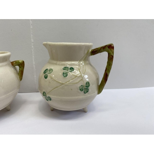 191 - A VINTAGE BELLEEK SUGAR BOWL AND CREAMER SET, this set is based on the shape of an antique Irish coo... 