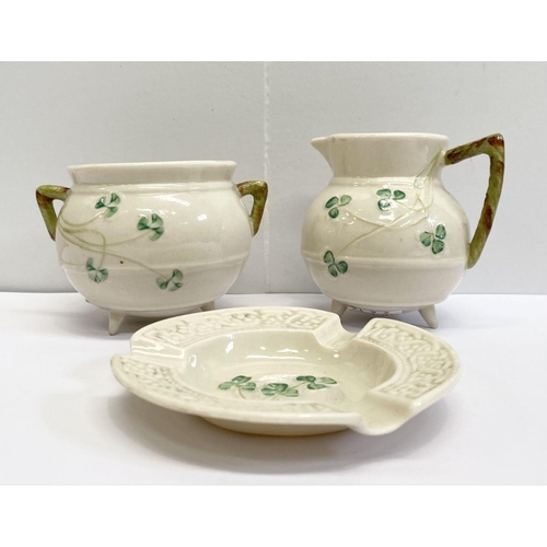 191 - A VINTAGE BELLEEK SUGAR BOWL AND CREAMER SET, this set is based on the shape of an antique Irish coo... 