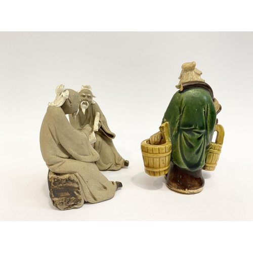 194 - A CHINESE CLAY SHIWAN FIGURINE, depicting two seated ‘mudman’ figures in traditional dress conversin... 