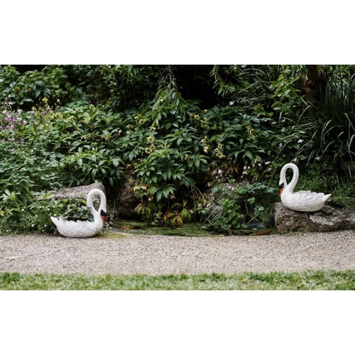 23 - A PAIR OF CAST IRON GARDEN SWAN PLANTERS, dimensions: 15 inches high x 18 inches long approx.