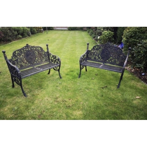 29 - A PAIR OF BLACK CAST IRON GARDEN LADY BENCHES, finely decorated with panel of reclining female figur... 