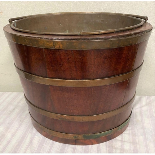 32 - A RECENCY MAHOGANY OVAL SHAPED BRASS BANDED PEAT BUCKET, with original liner and handle. Dimensions:... 