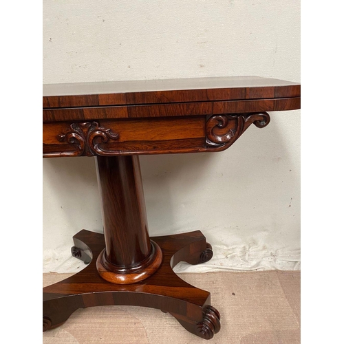 4 - A WILLIAM IV ROSEWOOD CARD TABLE, with lift top opening to navy blue baize, shaped engraved scroll f... 