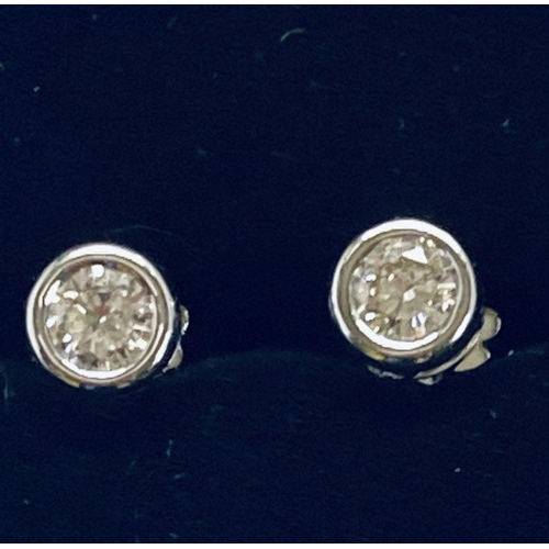 40 - A TIMELESS PAIR OF 18CT WHITE GOLD DIAMOND STUD EARRINGS, rub over diamond stud earrings, .75cts, di... 