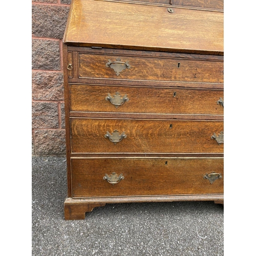 41 - A FINE GEORGIAN BUREAU BOOKCASE, with fluted cornice, two panelled doors above fold out desk with fi... 