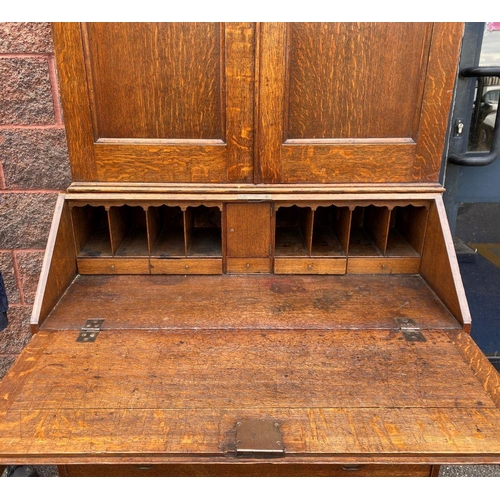 41 - A FINE GEORGIAN BUREAU BOOKCASE, with fluted cornice, two panelled doors above fold out desk with fi... 