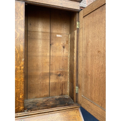 41 - A FINE GEORGIAN BUREAU BOOKCASE, with fluted cornice, two panelled doors above fold out desk with fi... 