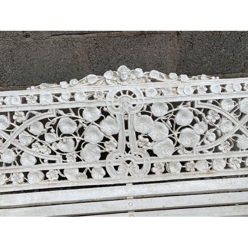 5 - A WHITE CAST IRON COALBROOKDALE STYLE GARDEN SEAT, ‘Nasturtium’ pattern to back, naturalistic scroll... 