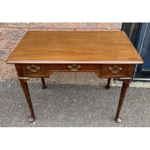 55 - A FINE QUEEN ANNE STYLE WRITING DESK, with moulded top, three drawers, brass handles, standing on ca... 