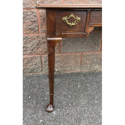 55 - A FINE QUEEN ANNE STYLE WRITING DESK, with moulded top, three drawers, brass handles, standing on ca... 