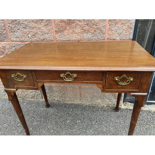 55 - A FINE QUEEN ANNE STYLE WRITING DESK, with moulded top, three drawers, brass handles, standing on ca... 