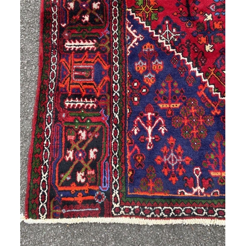 6 - A PERSIAN JOSHAGAN RUG, material: hand spun wool with natural organic dyes; design: this rug feature... 