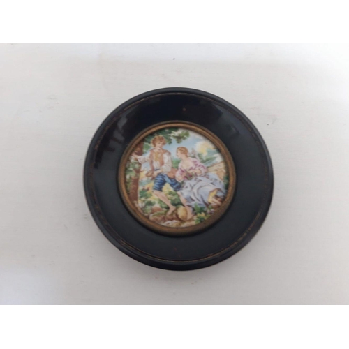 79 - A CIRCULAR FRAMED MINIATURE PAINTING ON PORCELAIN, depicting courting scene. Dimensions: 11cm diamet... 