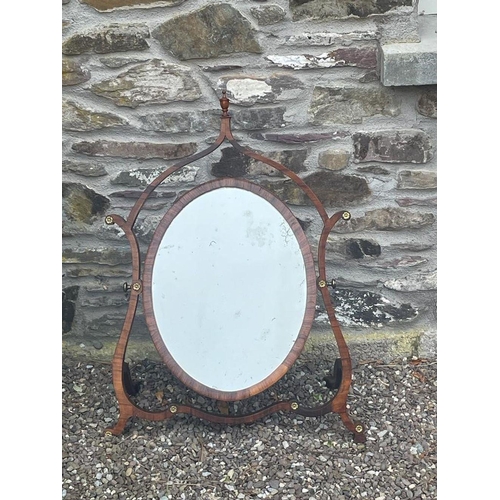 83 - A UNIQUE MAHOGANY DRESSING TABLE MIRROR, with oval mirror plate, in crossbanded frame, the swing mir... 