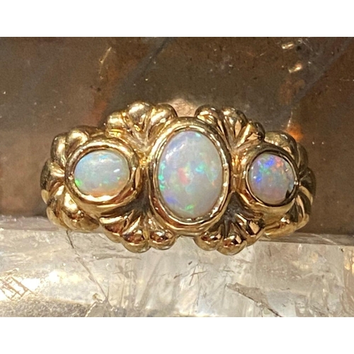 91 - A 9CT YELLOW GOLD EXQUISITE THREE STONE FIRE OPAL RING, the opals are in a bezel setting and surroun... 