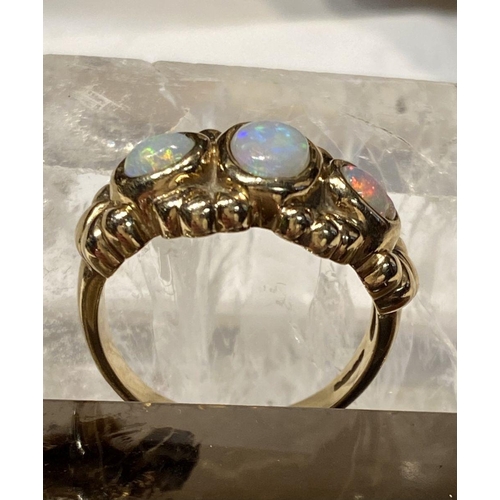 91 - A 9CT YELLOW GOLD EXQUISITE THREE STONE FIRE OPAL RING, the opals are in a bezel setting and surroun... 