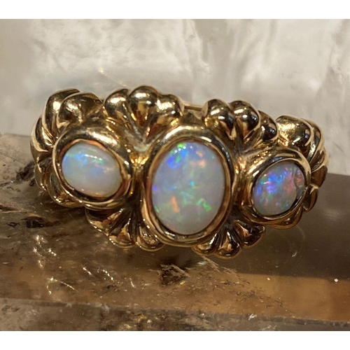 91 - A 9CT YELLOW GOLD EXQUISITE THREE STONE FIRE OPAL RING, the opals are in a bezel setting and surroun... 