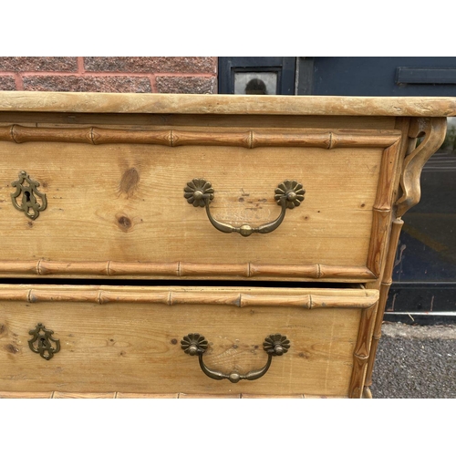 94 - A FRENCH OAK CHEST OF DRAWERS, three drawers with brass handles, with carved supports.