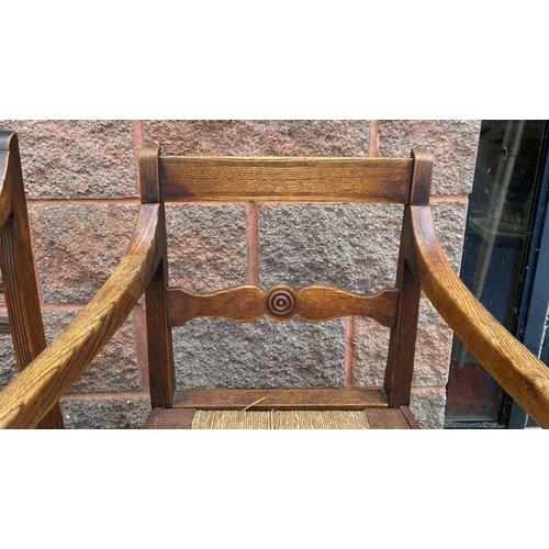 95 - TWO SOLID GEORGIAN ARMCHAIRS, both with cane seats, with carved back splats, turned armrests, suppor... 