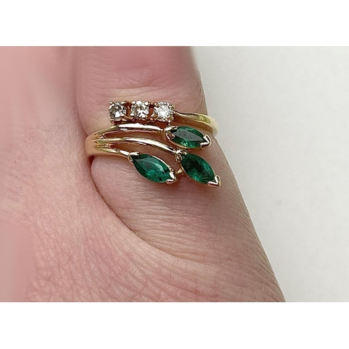 10 - A 14CT GOLD MARQUISE CUT EMERALD & DIAMOND RING, a really lovely elegant ring that feathers three st... 