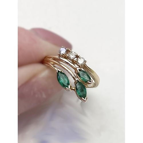 10 - A 14CT GOLD MARQUISE CUT EMERALD & DIAMOND RING, a really lovely elegant ring that feathers three st... 