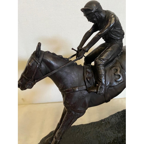 100 - A BRONZE HORSE & JOCKEY SCULTPURE, showing the horse in full flight jumping a fence, sitting on a ma... 