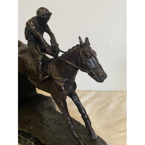 100 - A BRONZE HORSE & JOCKEY SCULTPURE, showing the horse in full flight jumping a fence, sitting on a ma... 