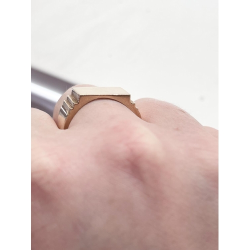 125 - A SOLID 14CT ROSE GOLD HEAVY SIGNET RING, with a nice simple design; a stepped edge from the flat to... 