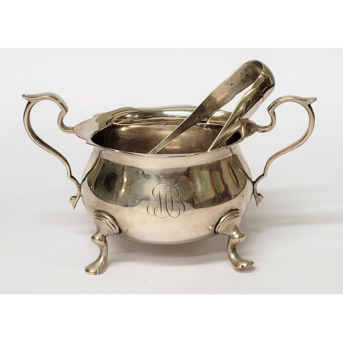 131 - A STERLING SILVER SUGAR BOWL & NIPS, the bowl with a pair of scrolling handles and scallop rim, rais... 