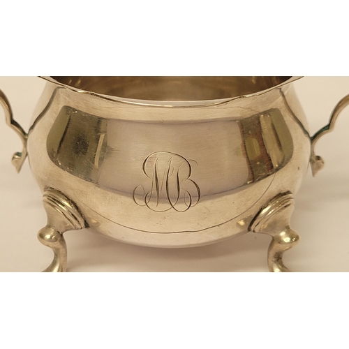 131 - A STERLING SILVER SUGAR BOWL & NIPS, the bowl with a pair of scrolling handles and scallop rim, rais... 