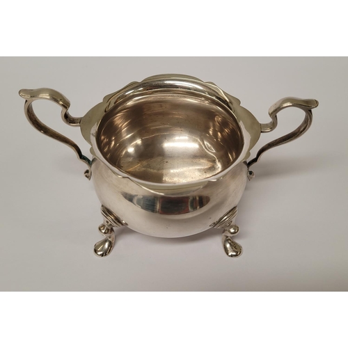 131 - A STERLING SILVER SUGAR BOWL & NIPS, the bowl with a pair of scrolling handles and scallop rim, rais... 