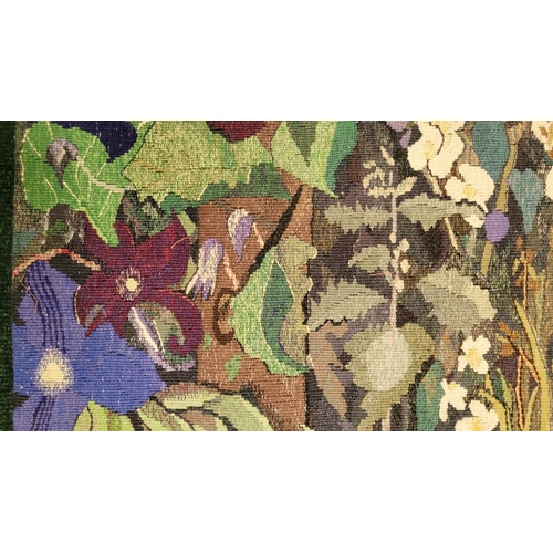 133 - TWO ARTS & CRAFTS WOVEN PICTURE PANELS. (i) The larger is a floral and still life scene, with variou... 