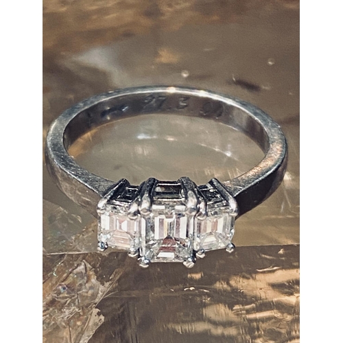 149 - A PLATINUM CLAW SET EMERALD CUT THREE STONE DIAMOND RING, the three emerald cut diamonds come in at ... 